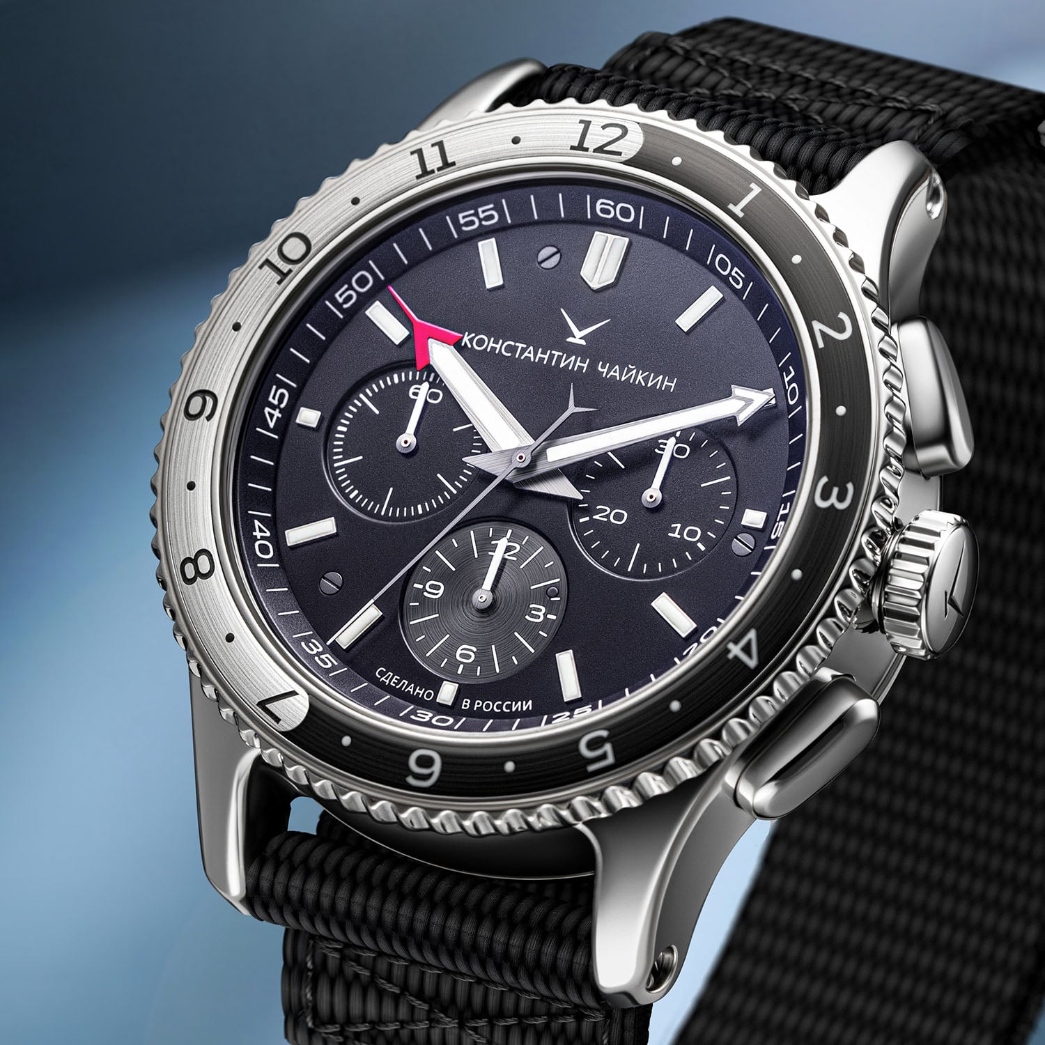 Close view of the SC02C black dial with three chronograph registers, applied luminous markers, a red-tipped central hand and the Cyrillic Konstantin Chaykin signature