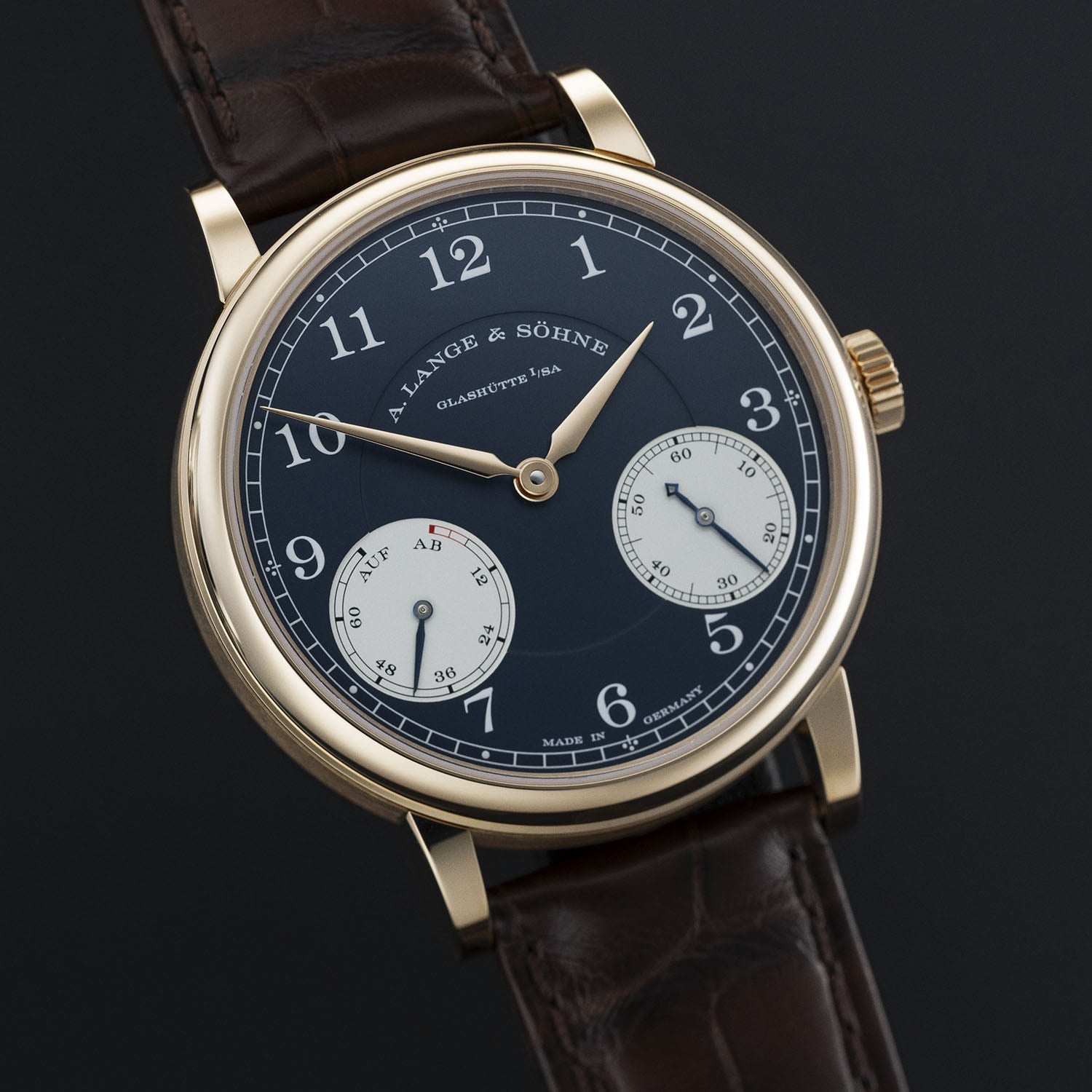 The pink gold 1815 Up/Down, blue dial with white pad-printed Arabic numerals, lancet-shaped pink gold hands and a fluted pink gold crown, on a reddish-brown alligator strap