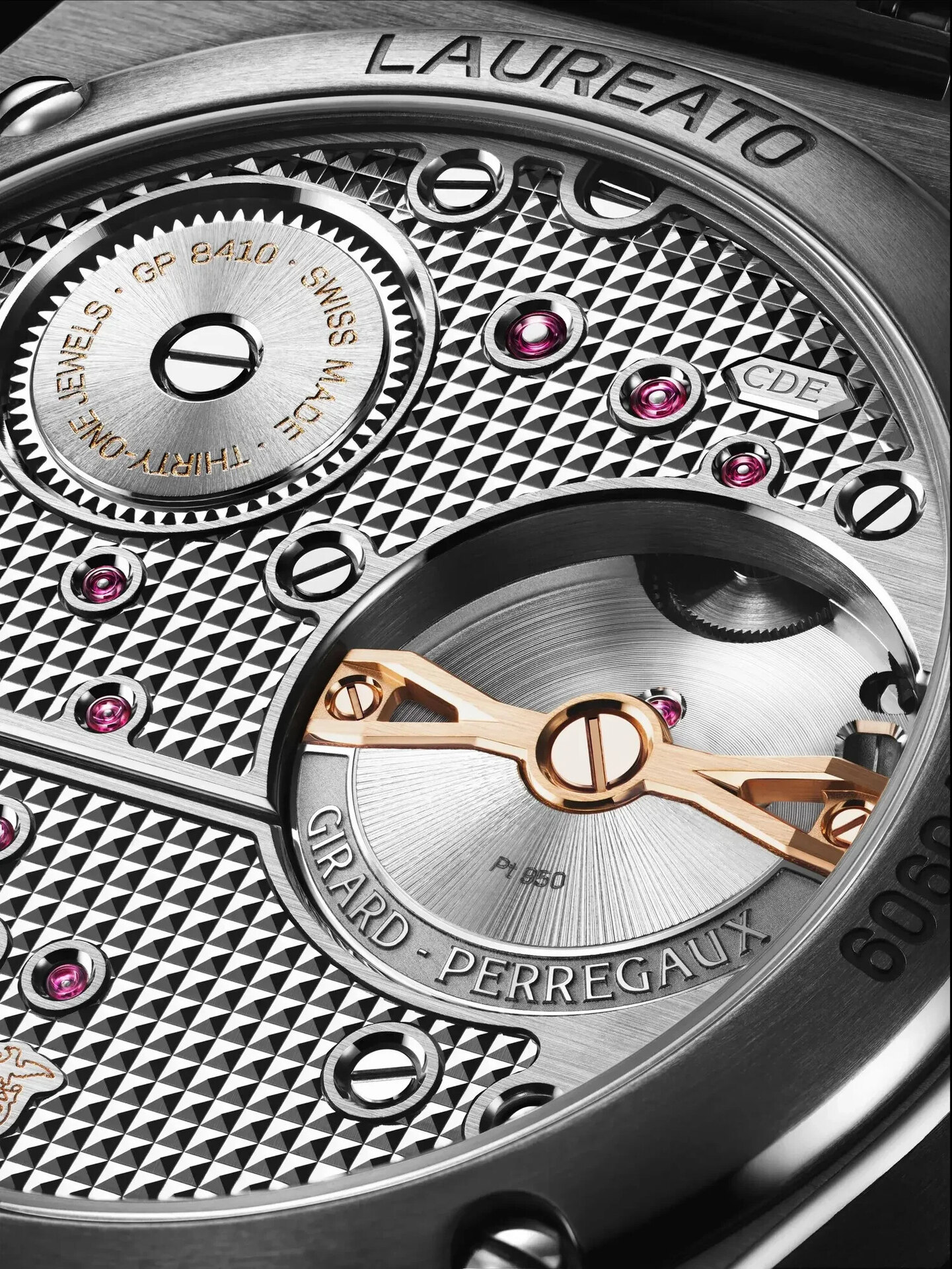 Macro of the Girard-Perregaux calibre GP8410 through the sapphire back, the platinum-and-pink-gold micro-rotor on its arrow-shaped bridge and the white-gold bridges decorated with Clous de Paris
