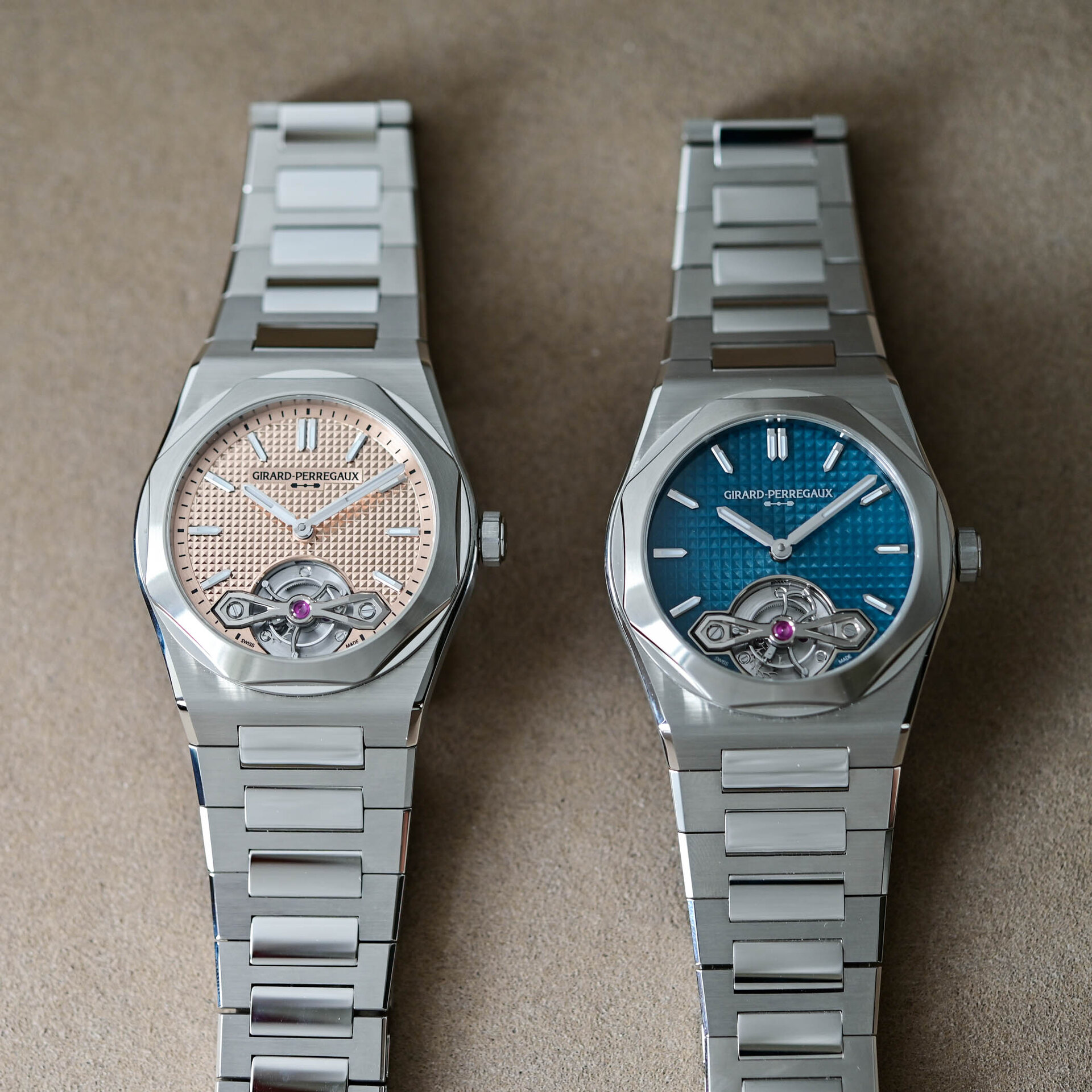 Both Laureato Fifty Tourbillon dials side by side, the rose-gold ref 99116-11-3615-1CM at left and the blue Grand Feu enamel ref 99116-11-3528-1CM at right, on steel bracelets