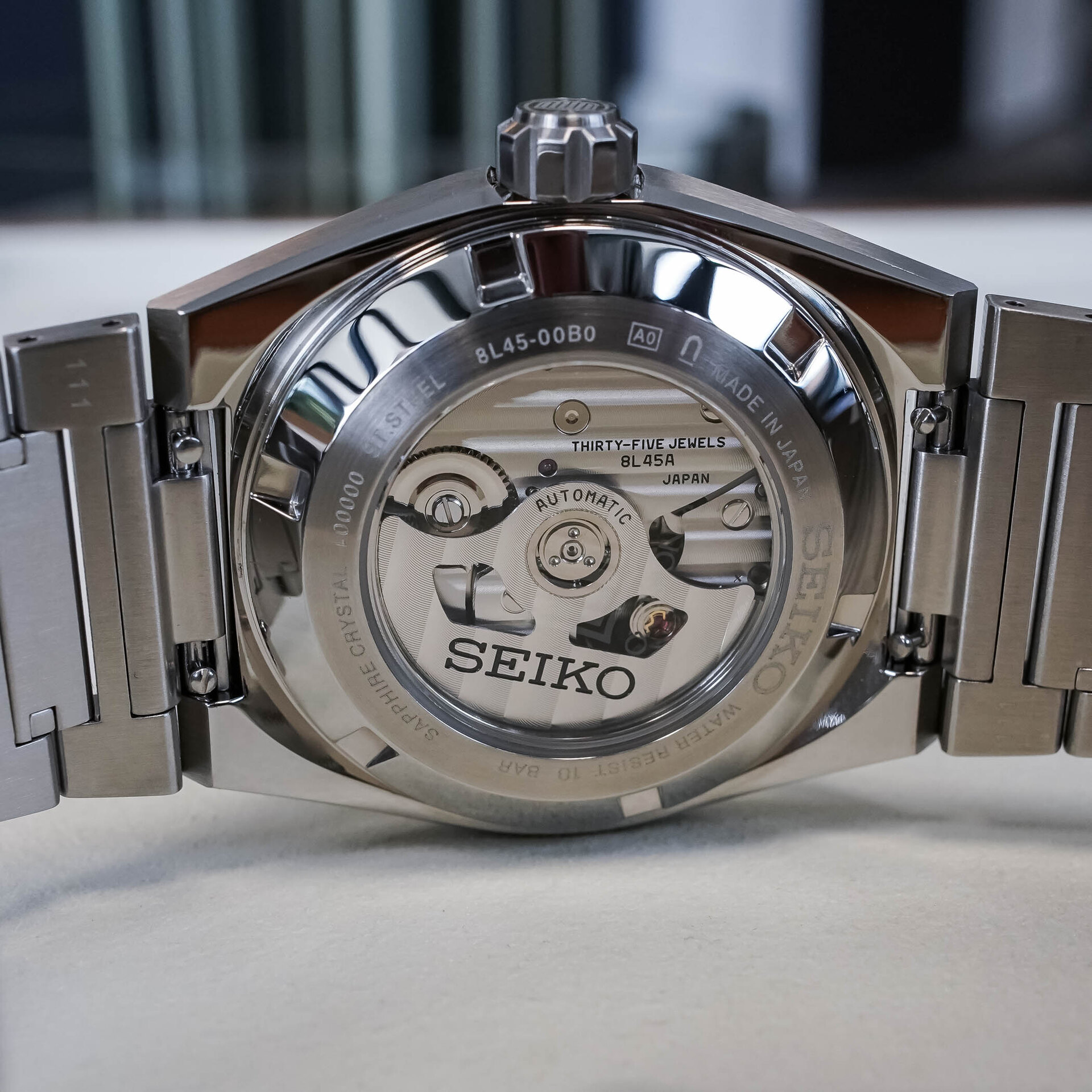 Sapphire screw-down caseback of the HKF005 showing the automatic Calibre 8L45A engraved THIRTY-FIVE JEWELS, with striped finishing on the bridges and rotor