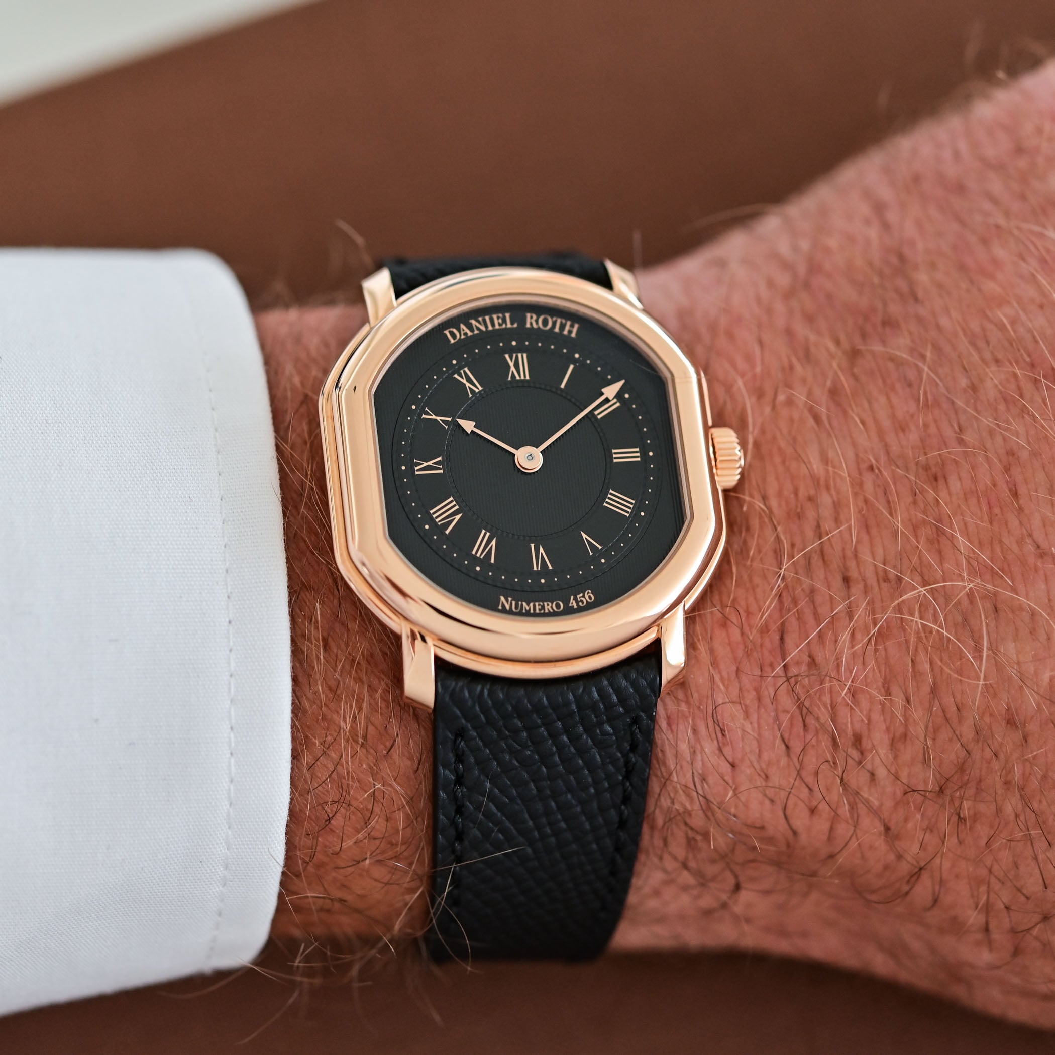 The Daniel Roth Extra Plat Rose Gold Gilt on the wrist, the rose-gold double-ellipse case and black gilt dial beneath a shirt cuff
