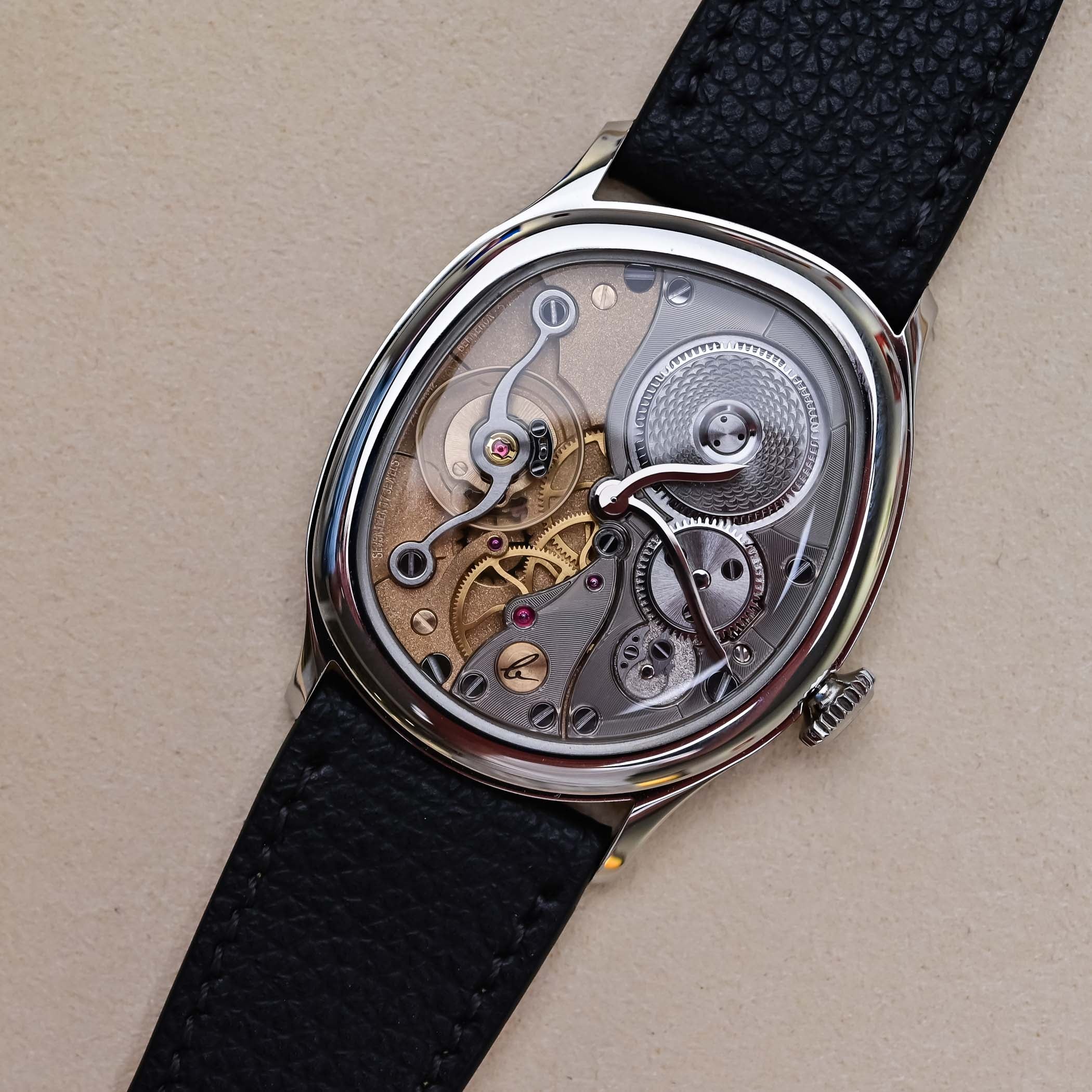 The white gold Mirage 38 Miroir seen flat from above, its openworked mirrored Calibre 283 with the balance at left, a guilloche barrel at upper right and the Berneron b signature engraved on a bridge