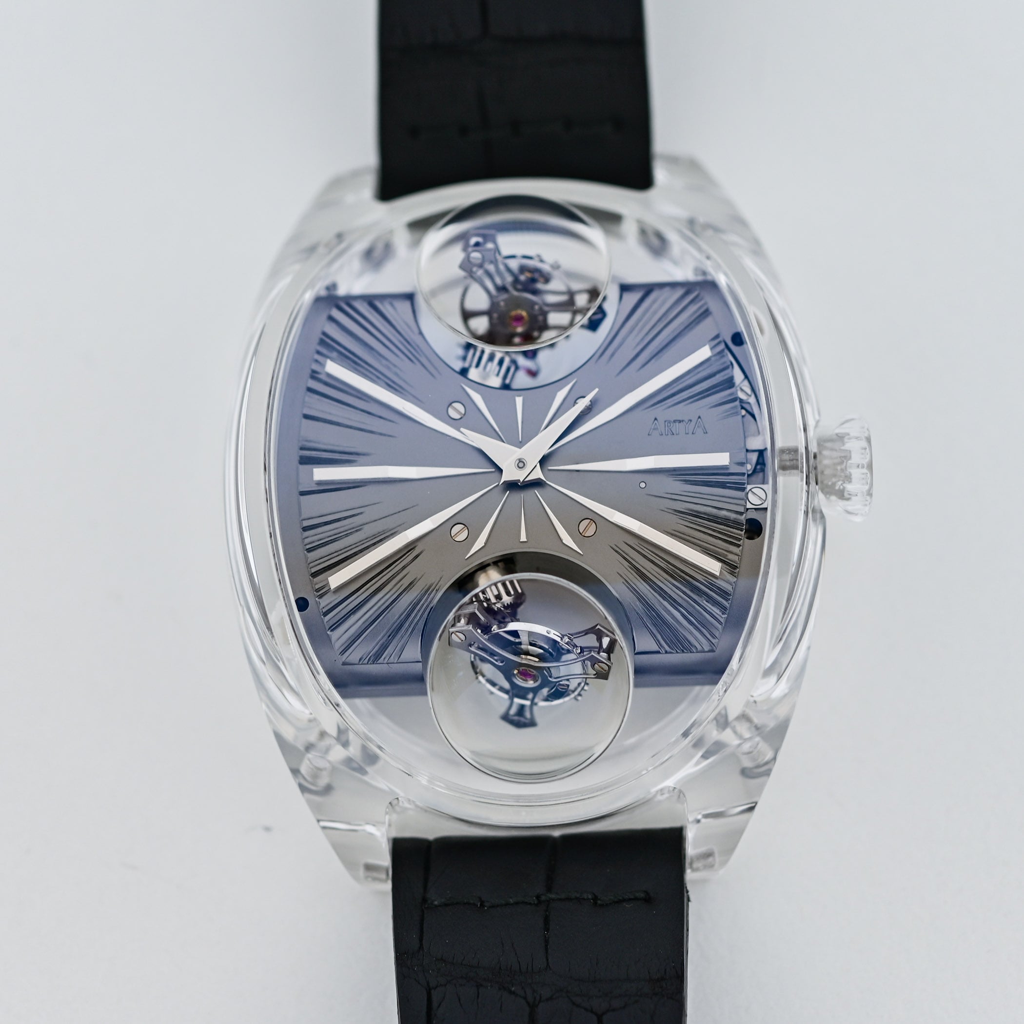 Front view of the ArtyA Complexity Métiers d'Art dial, a hand-engraved blue surface with radiating lines and two inclined tourbillons visible at 12 and 6 o'clock under magnifying sapphire domes