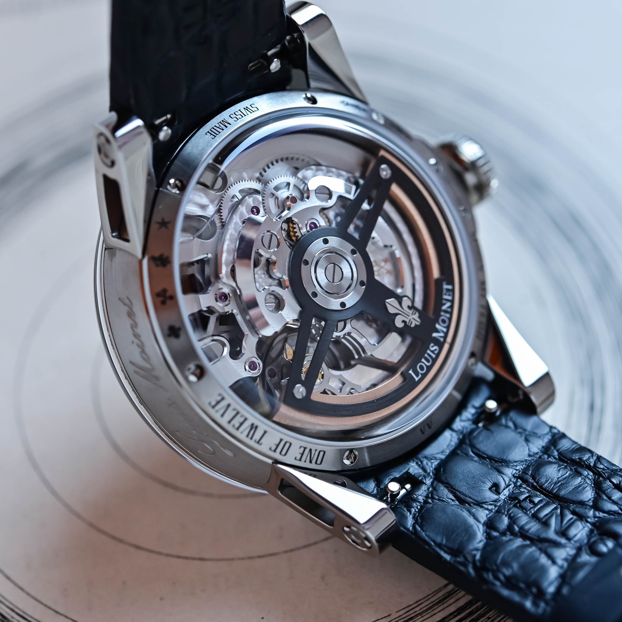 The skeletonised display caseback of the Moon Meteor engraved One of Twelve and Swiss Made, showing the self-winding LM113 calibre